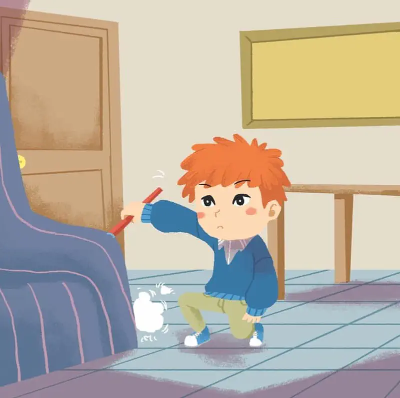 Boy crouching to sweep dust from under blue couch with dustpan