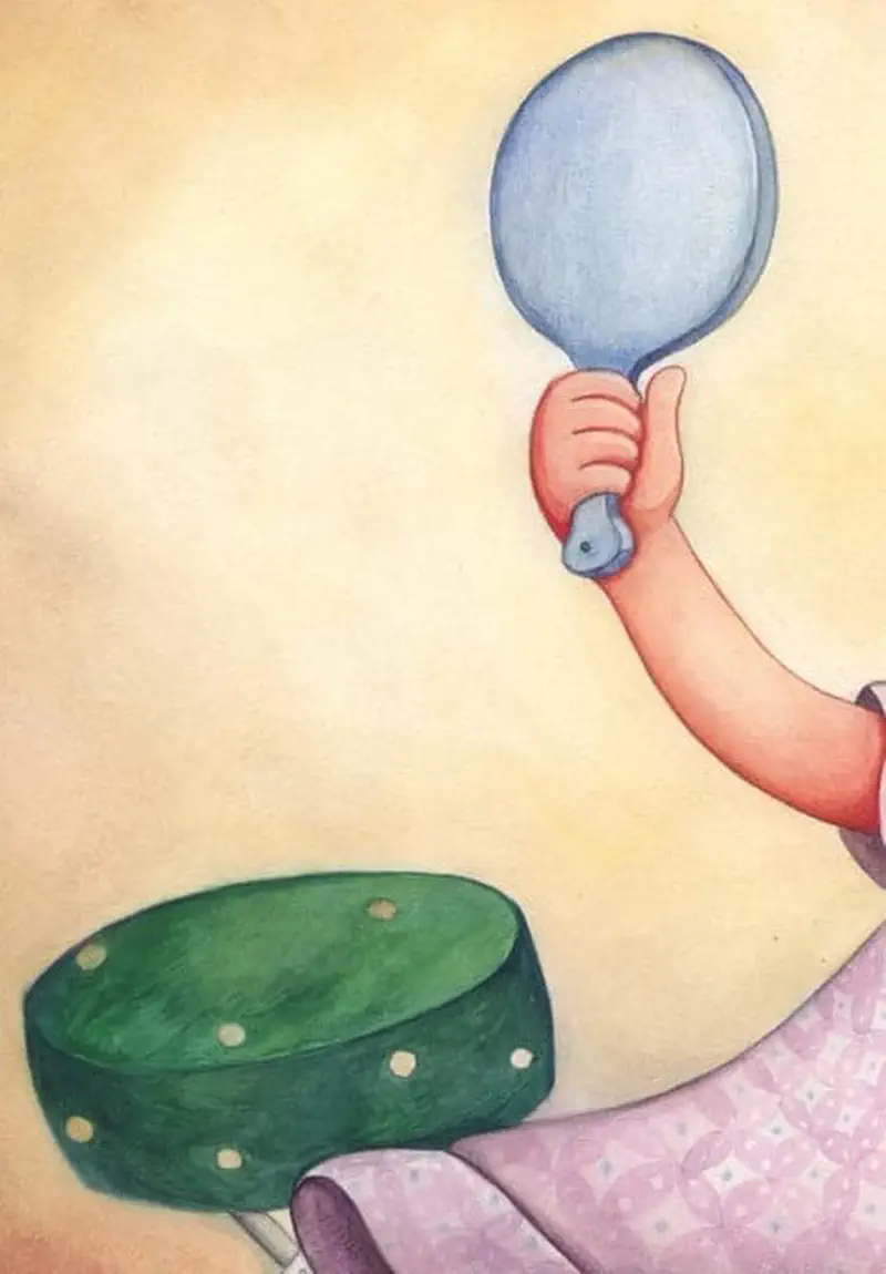 Close-up of child's hand holding blue hand mirror while sitting on green polka dot stool wearing pink dress