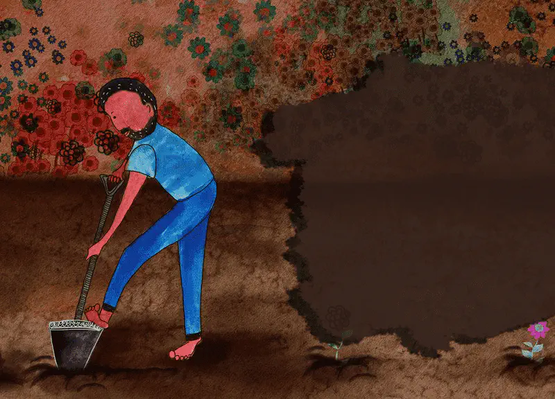 Man bending over digging with shovel in brown dirt patch surrounded by flowers