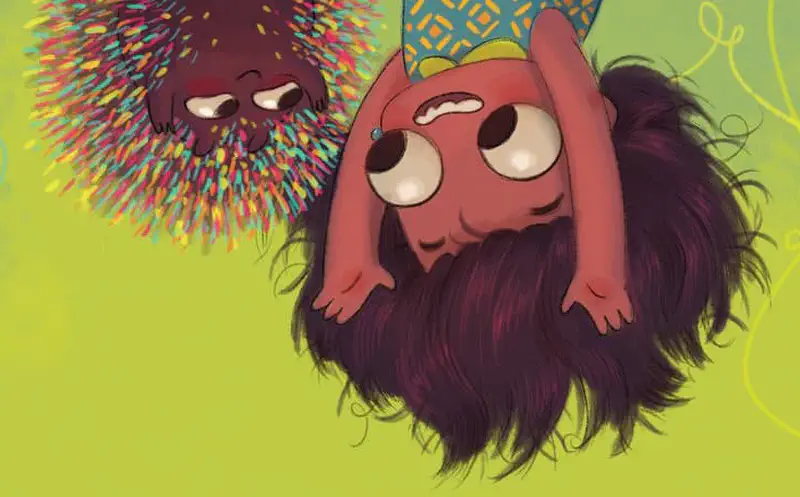 Boy sitting on ground with small tan puppy licking his face happily