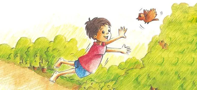 Happy boy in red shirt running and waving at brown bird flying over green hillside