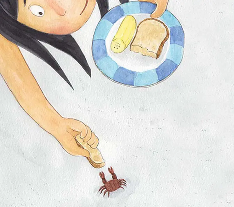 Girl with black hair offering bread to small crab on beach while holding plate with food