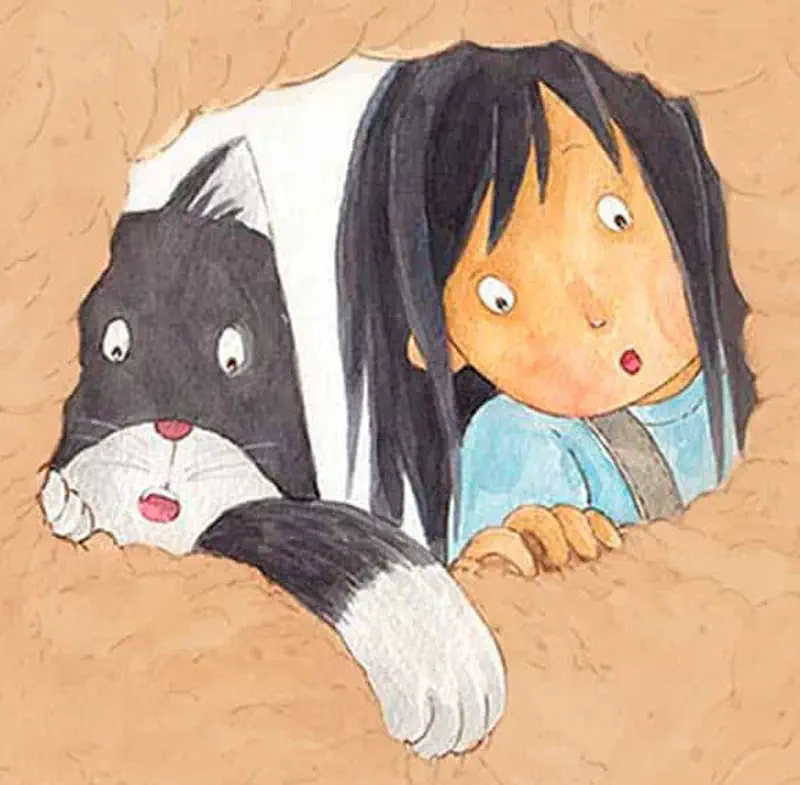 Girl and black and white cat lying flat on sandy ground watching something with curious expressions