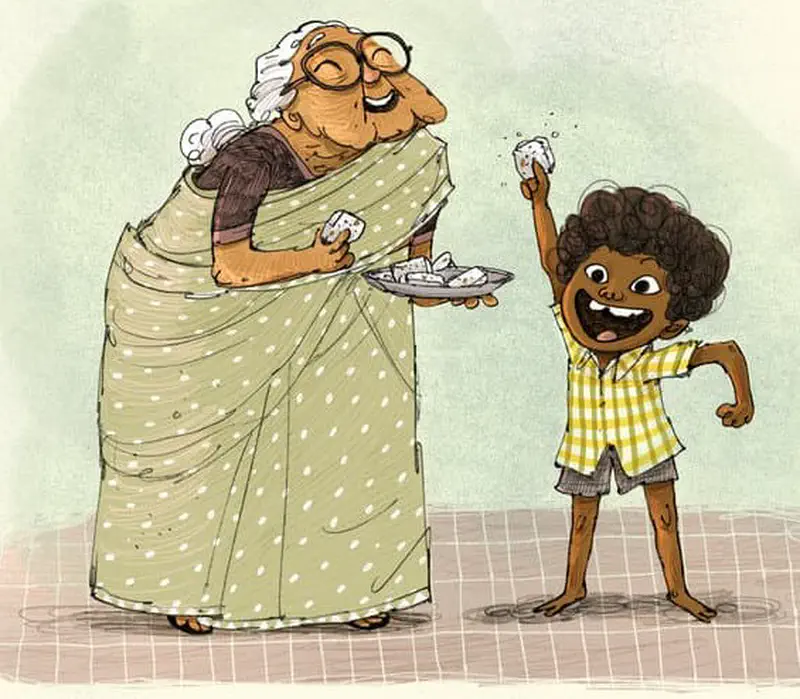 Grandmother holds a plate of coconut treats while the happy boy raises one piece in the air, ready to eat.