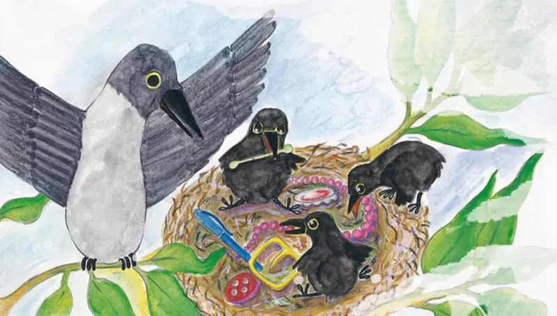A grey crow with wings spread arrives at a nest with four black chicks playing with colorful trinkets, beads, scissors and buttons.