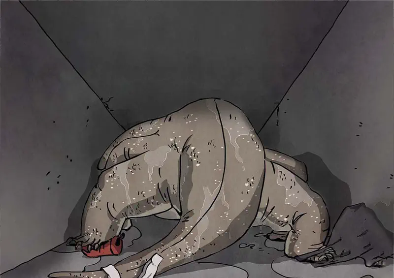 A large gray monitor lizard curled up sleeping in a dark concrete corner holding a red object in its mouth.