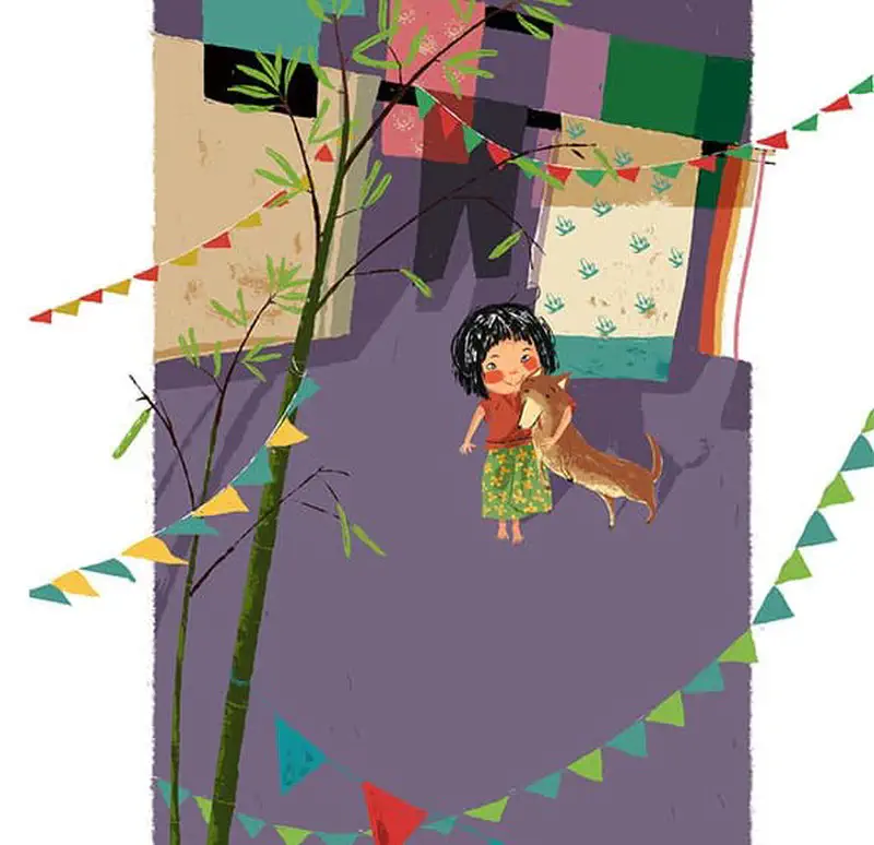 The girl hugs her dog in a village setting decorated with colorful bunting flags, bamboo plants, and hanging laundry.