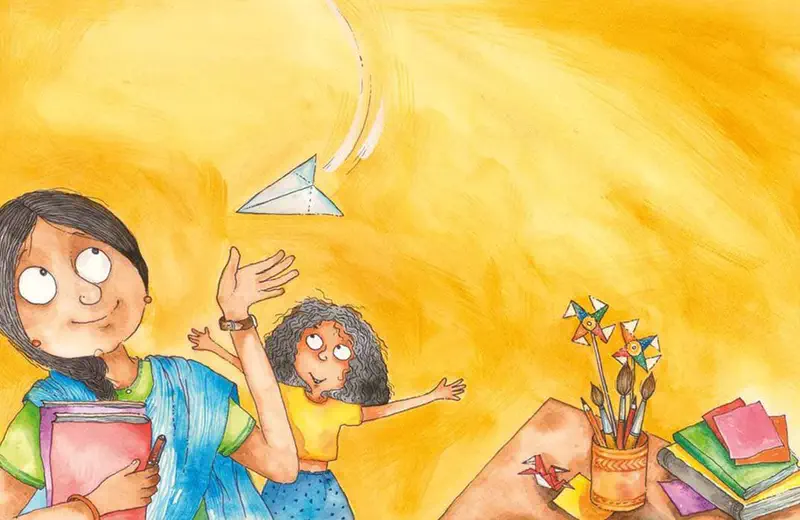 Teacher in blue sari holds books while a girl throws a paper airplane in a yellow room with pinwheels, origami, and art supplies on a desk.