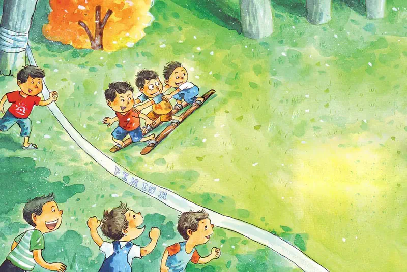 Children race toward the finish line in a three-legged race while others cheer them on at a festive outdoor event with trees.