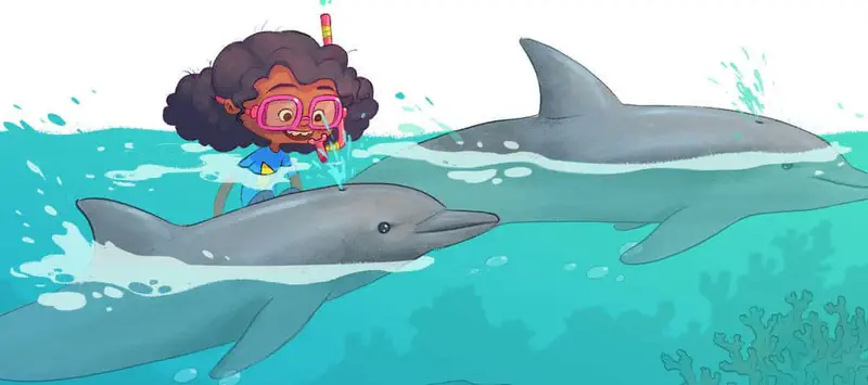 Girl with curly hair and pink snorkel mask swims at the surface with two gray dolphins gliding through the turquoise water below.