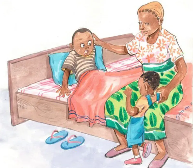 Mother comforting crying boy in bed while younger brother looks up at them with slippers on floor.