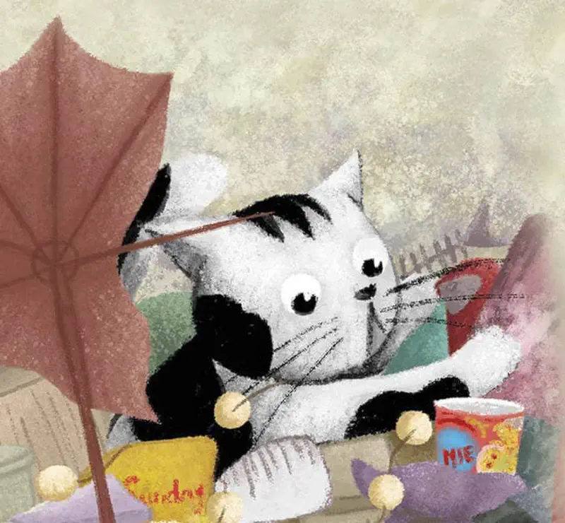 Black and white cat holding umbrella surrounded by colorful junk pile with noodle cup nearby.