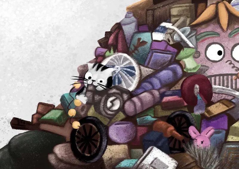 Cat hiding in colorful junk pile with pink monster face, wheels and toys scattered around.