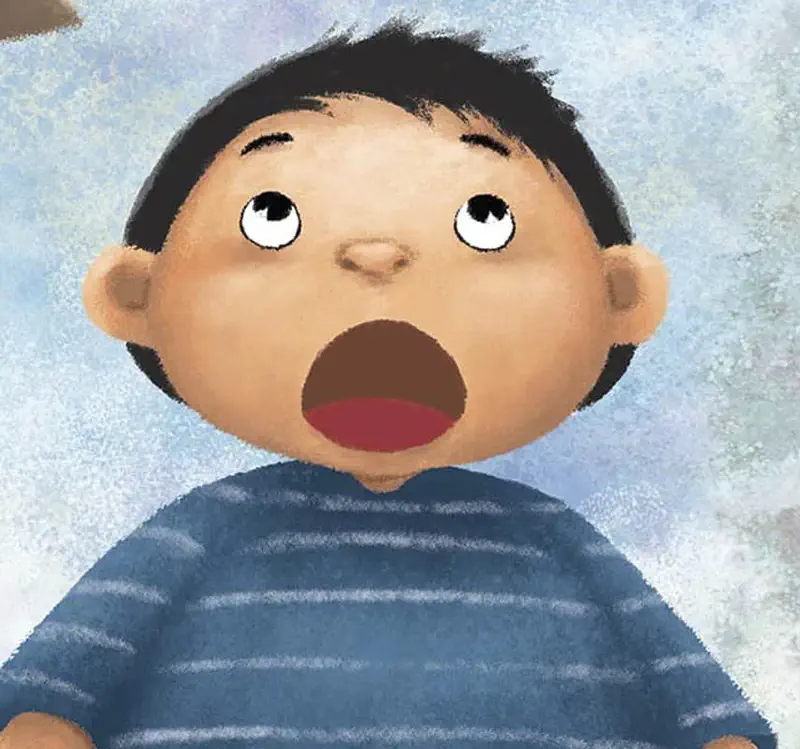 Close-up of boy with wide open mouth looking shocked, wearing blue striped shirt.