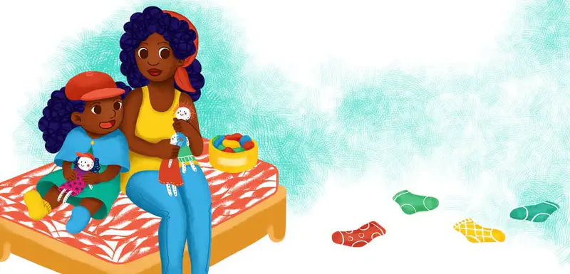 Mother and daughter sitting on bed with dolls and colorful socks scattered on floor.