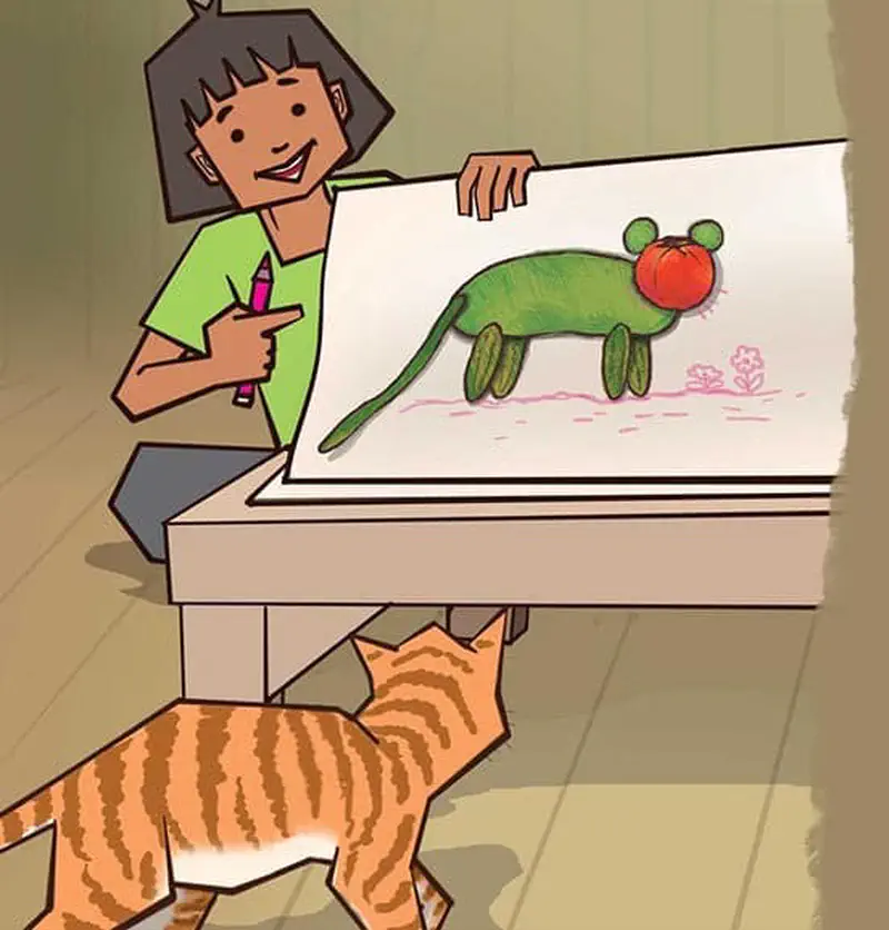 Smiling boy showing drawing of vegetable cat to orange striped cat walking across wooden floor.
