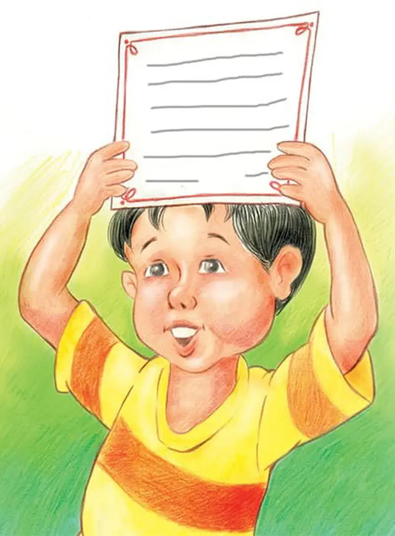Excited boy holding lined paper above head against green grassy background.
