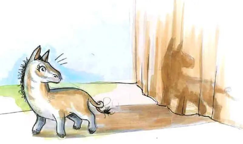 Striped horse looking surprised at its own shadow cast on sandy cliff wall.