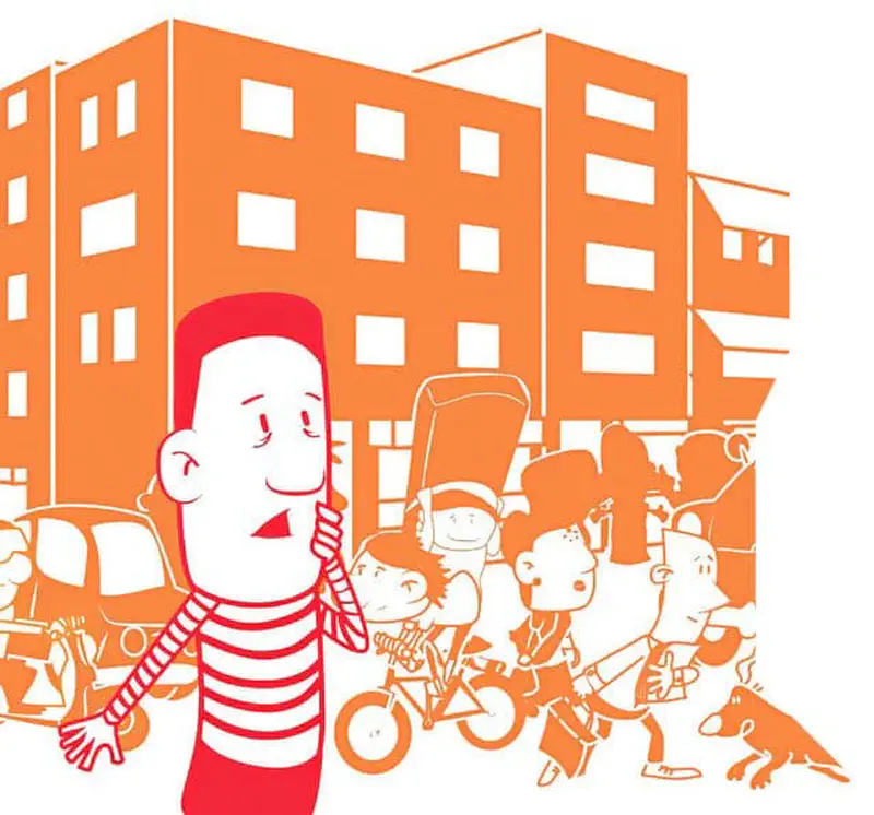 A boy in red striped shirt talks on a phone while people on bikes and walking pass by in an orange city.