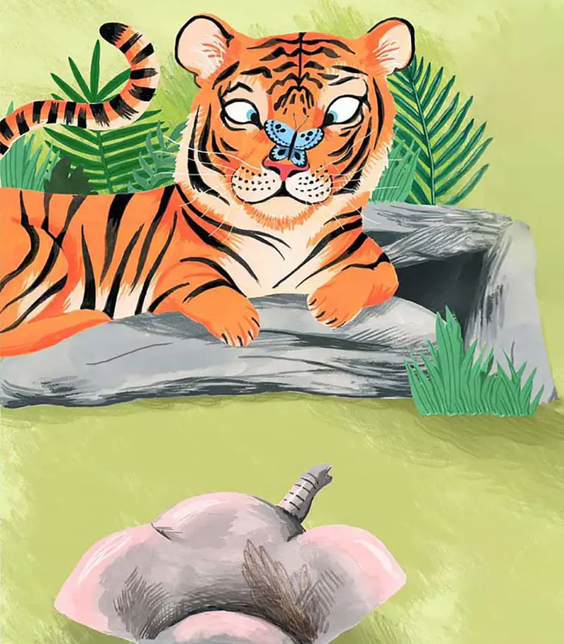An orange tiger with a butterfly on its nose lies on rocks while a baby elephant peeks from below.