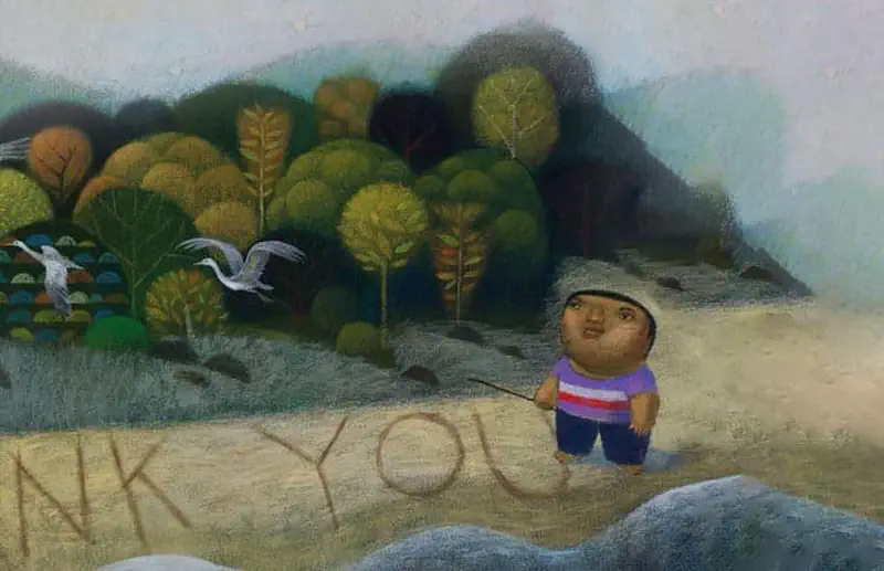 A boy in purple writes 'Thank You' in the sand on a beach with a stick, while white herons fly nearby and lush green trees cover the hillside.