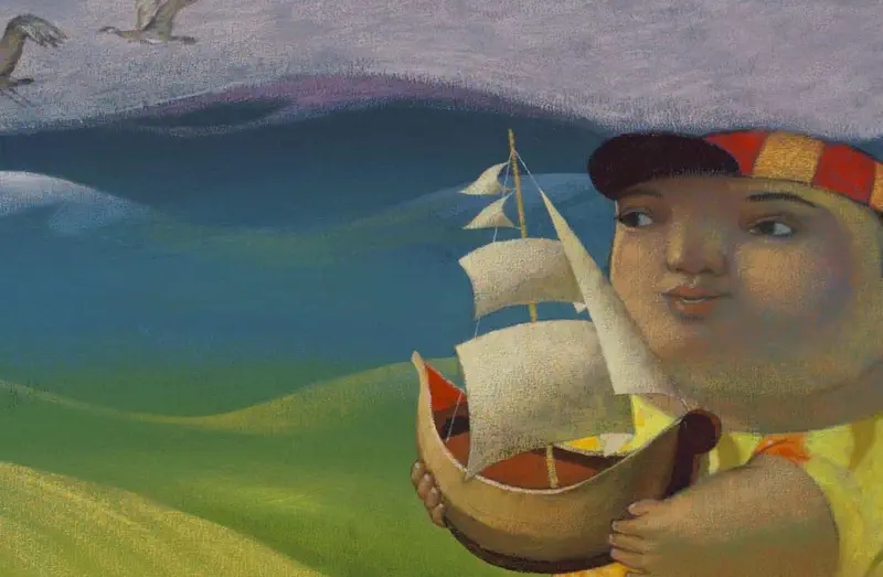 A smiling boy in a striped cap and yellow shirt holds a wooden toy sailing ship near the sea with mountains and seagulls in the background.