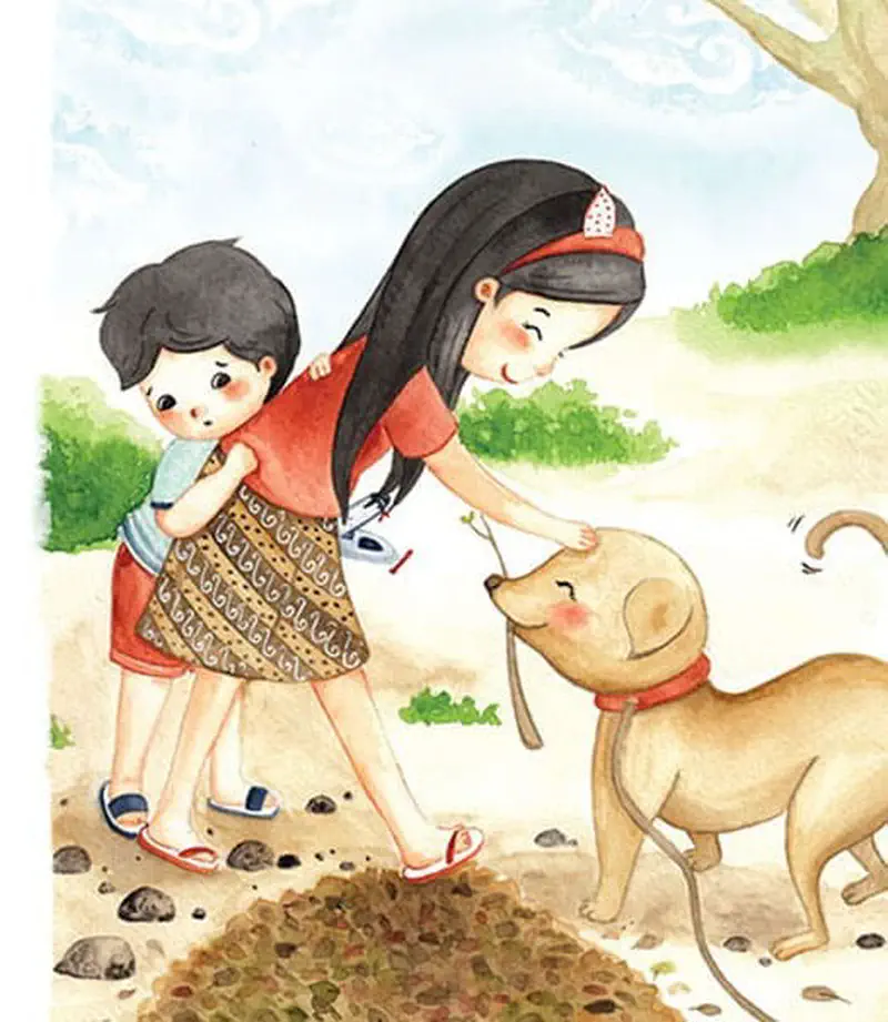 A girl pats a happy tan dog while carrying her little brother on her hip. They stand near a pile of dirt with a tree in the background.