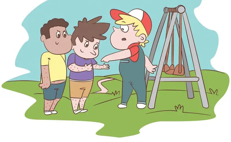 Two boys with fake red spots talk to a worried Ted near the swings, pointing at their spotted arms.