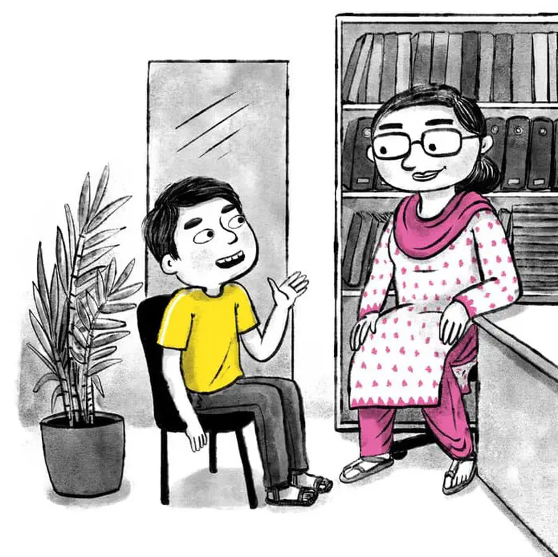 A boy in a yellow shirt talks with a woman wearing glasses and pink traditional clothing in an office with bookshelves.