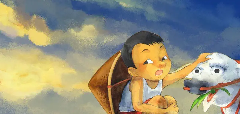 Close-up of a worried child with a straw hat on their back, gently touching a tired cow's face against a dramatic evening sky.